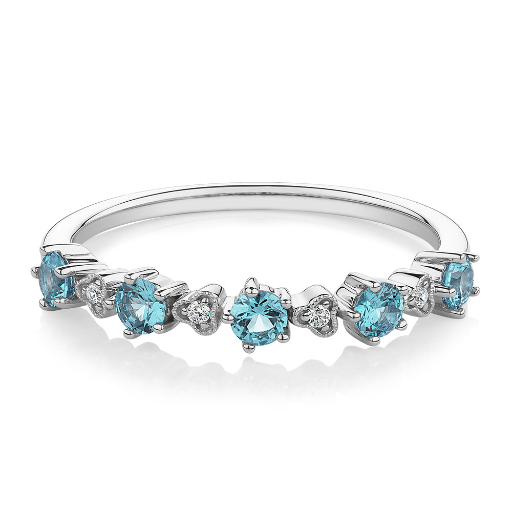 Wedding or eternity band with blue topaz and diamond simulants in 10 carat white gold