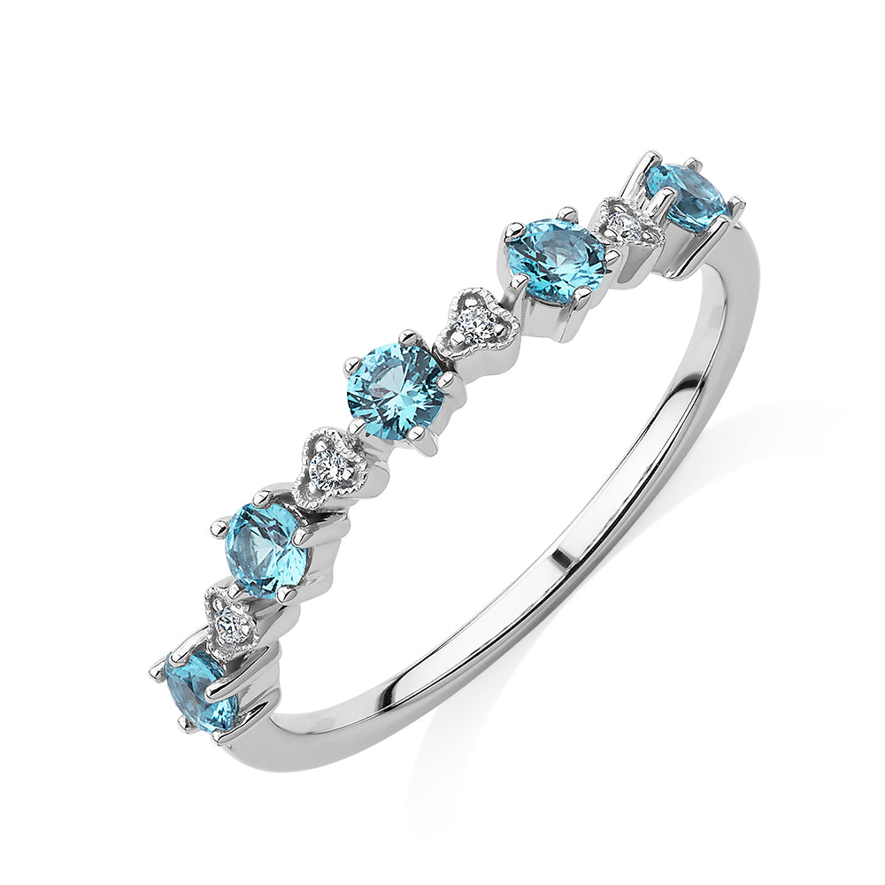 Wedding or eternity band with blue topaz and diamond simulants in 10 carat white gold