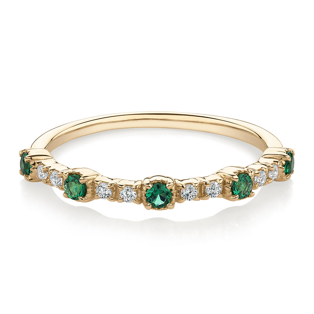 Wedding or eternity band with emerald and diamond simulants in 10 carat yellow gold