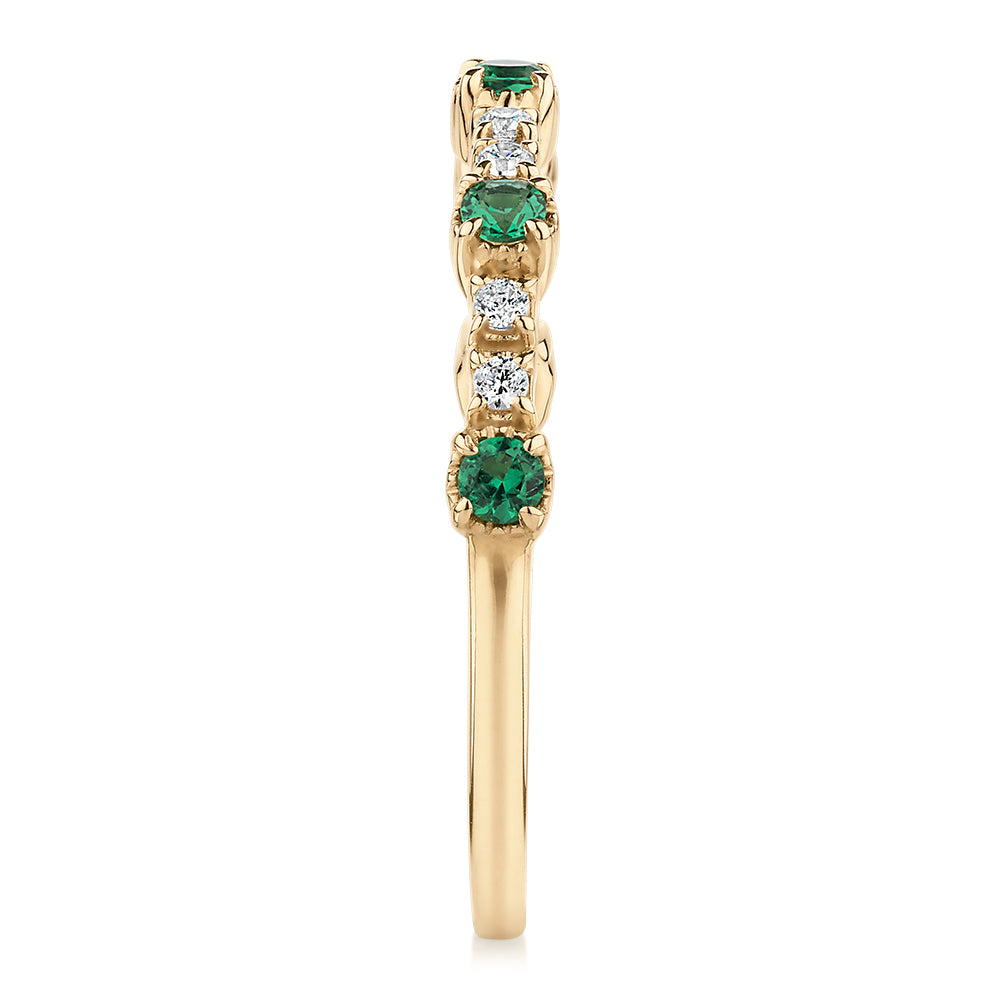 Wedding or eternity band with emerald and diamond simulants in 10 carat yellow gold