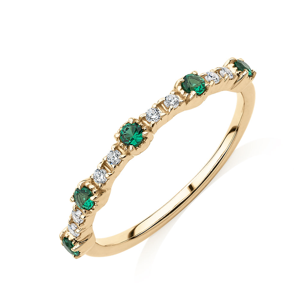 Wedding or eternity band with emerald and diamond simulants in 10 carat yellow gold