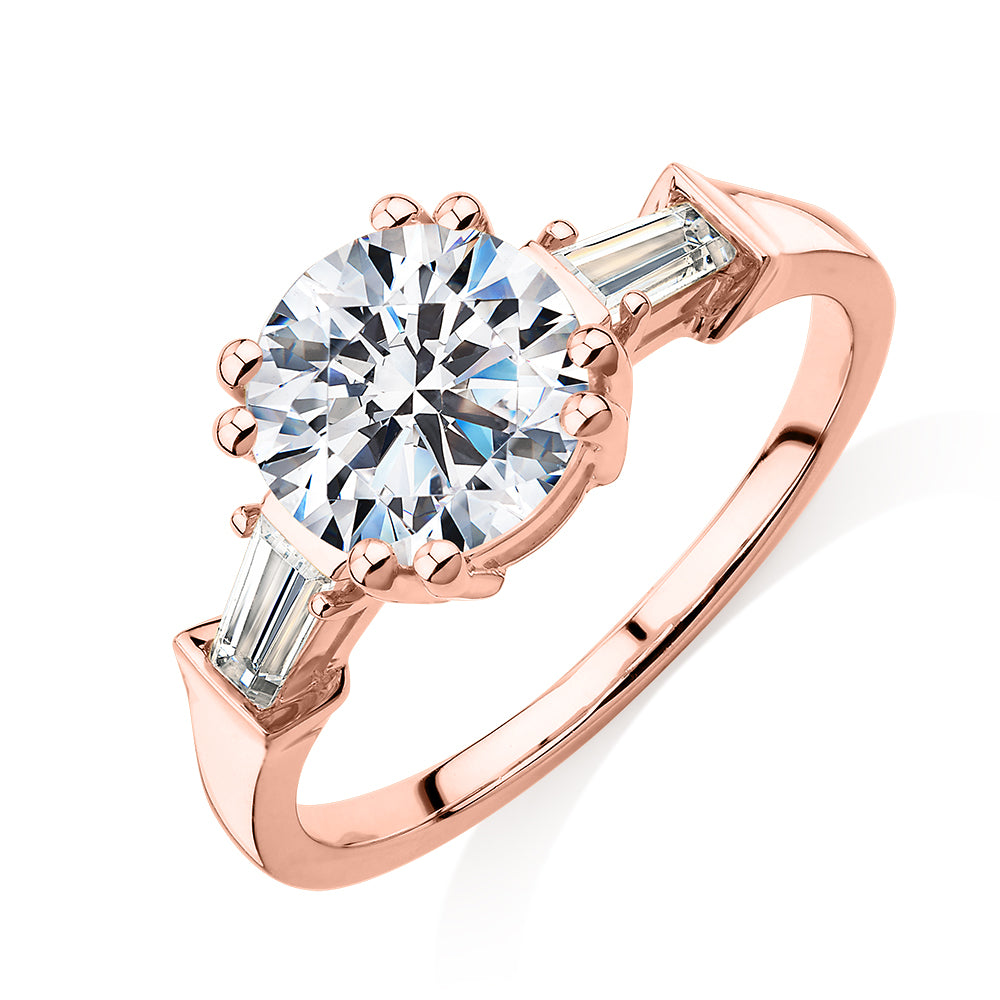 Round Brilliant and Baguette shouldered engagement ring with 2.46 carats* of diamond simulants in 10 carat rose gold