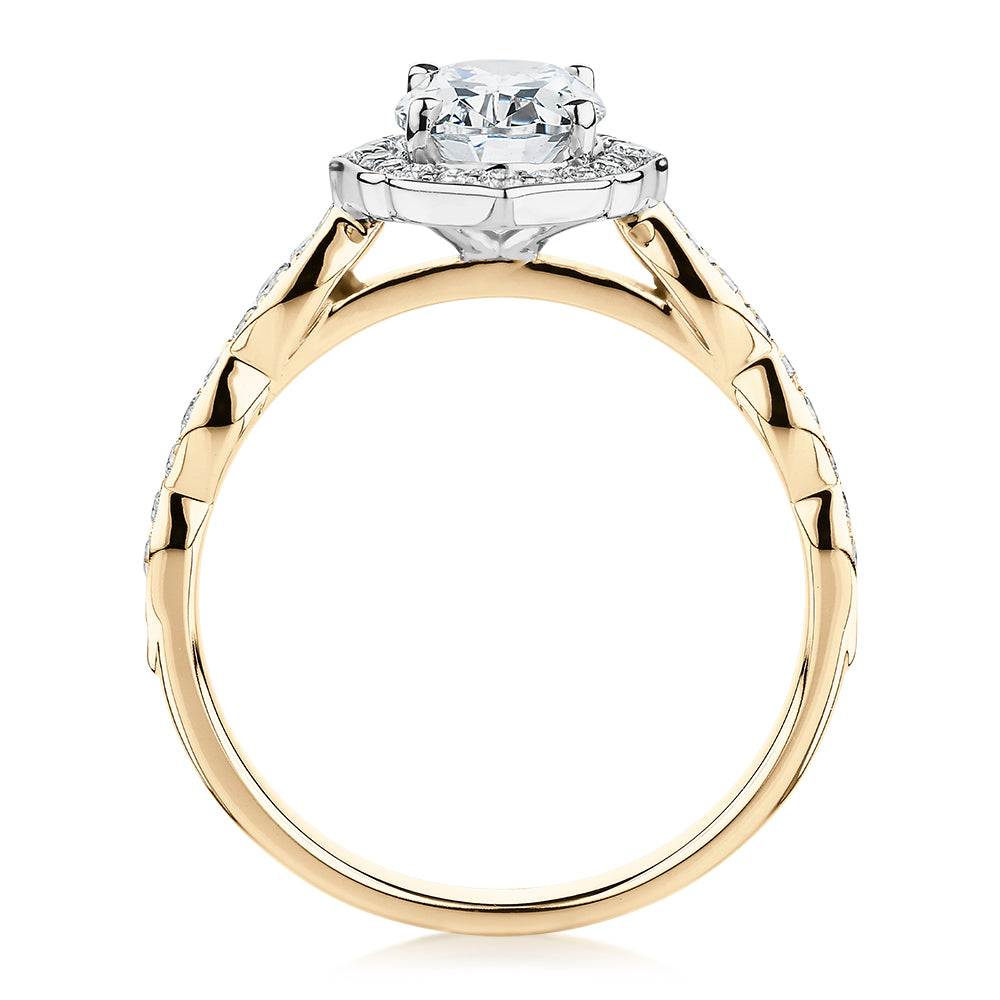 Oval halo engagement ring with 1.55 carats* of diamond simulants in 14 carat yellow and white gold