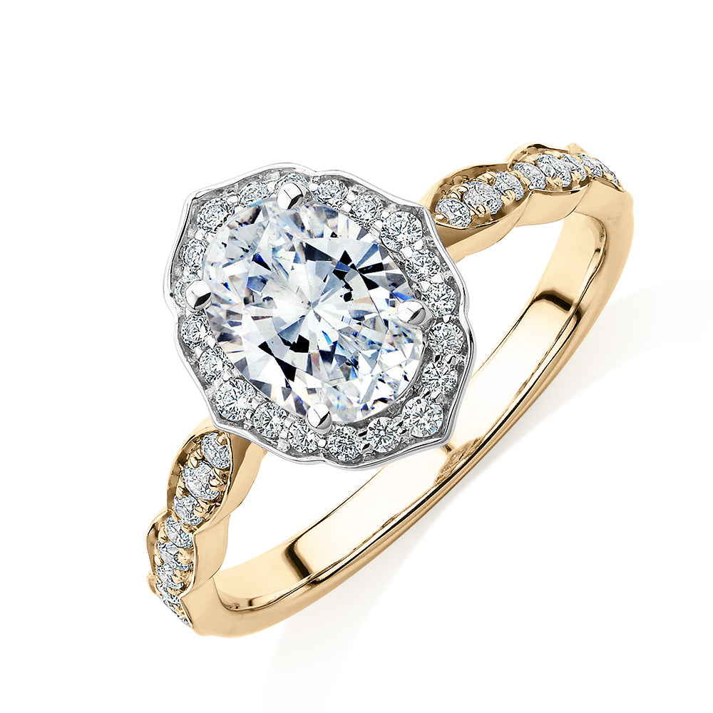 Oval halo engagement ring with 1.55 carats* of diamond simulants in 14 carat yellow and white gold