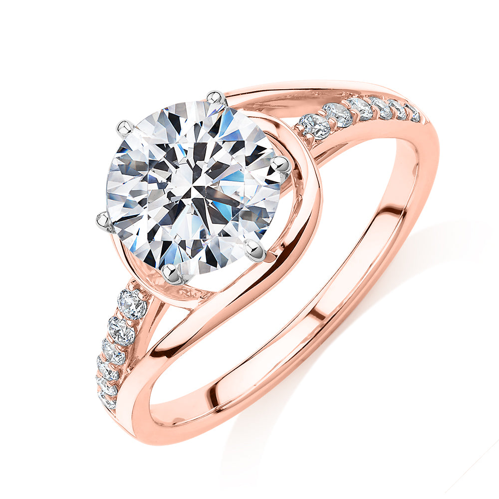 Round Brilliant shouldered engagement ring with 2.18 carats* of diamond simulants in 14 carat rose and white gold