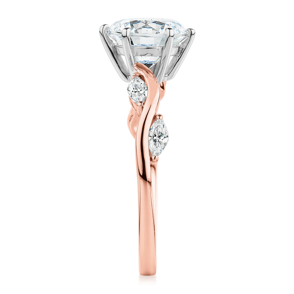 Round Brilliant and Marquise shouldered engagement ring with 2.44 carats* of diamond simulants in 14 carat rose and white gold