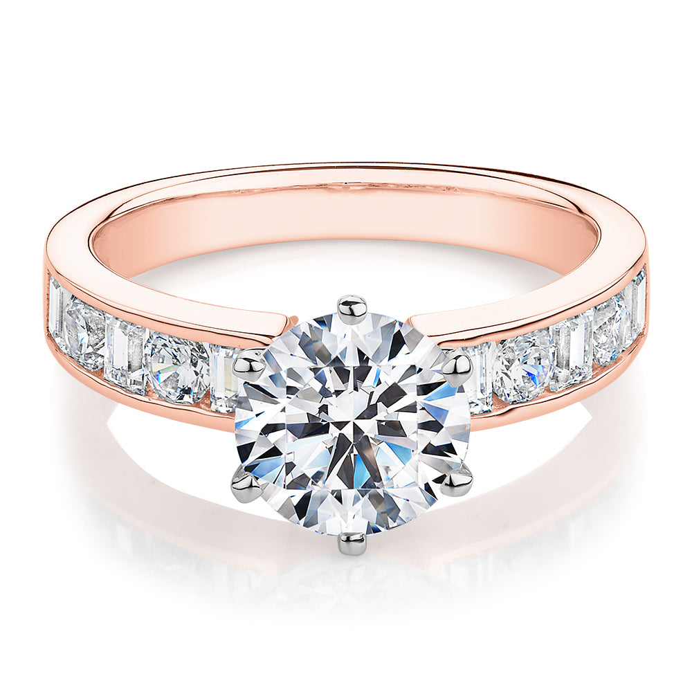 Round Brilliant and Baguette shouldered engagement ring with 2.72 carats* of diamond simulants in 14 carat rose and white gold