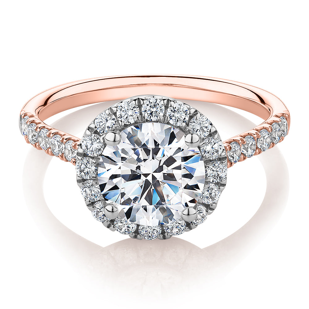 Round Brilliant halo engagement ring with 2.46 carats* of diamond simulants in 10 carat rose and white gold