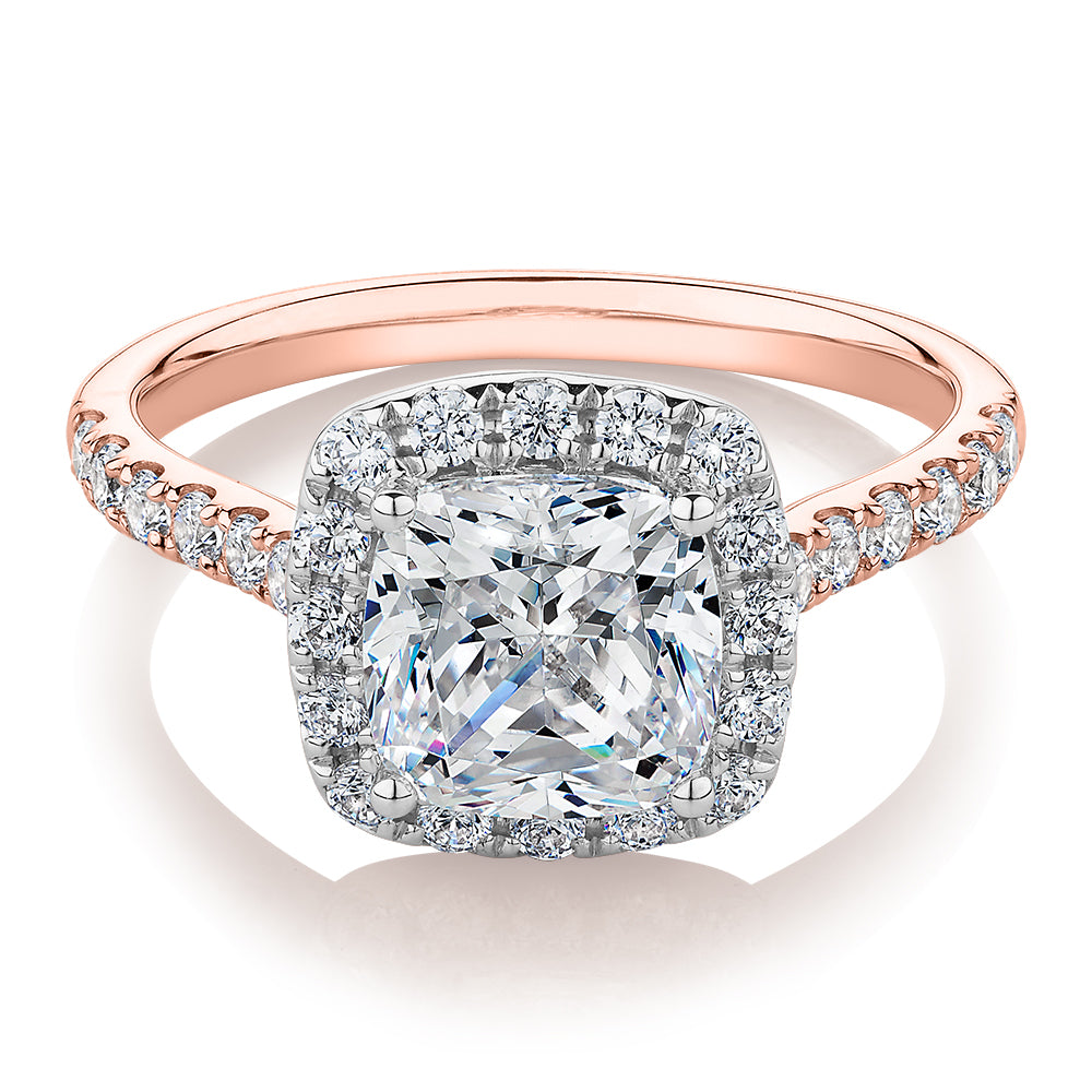 Cushion and Round Brilliant halo engagement ring with 2.09 carats* of diamond simulants in 10 carat rose and white gold