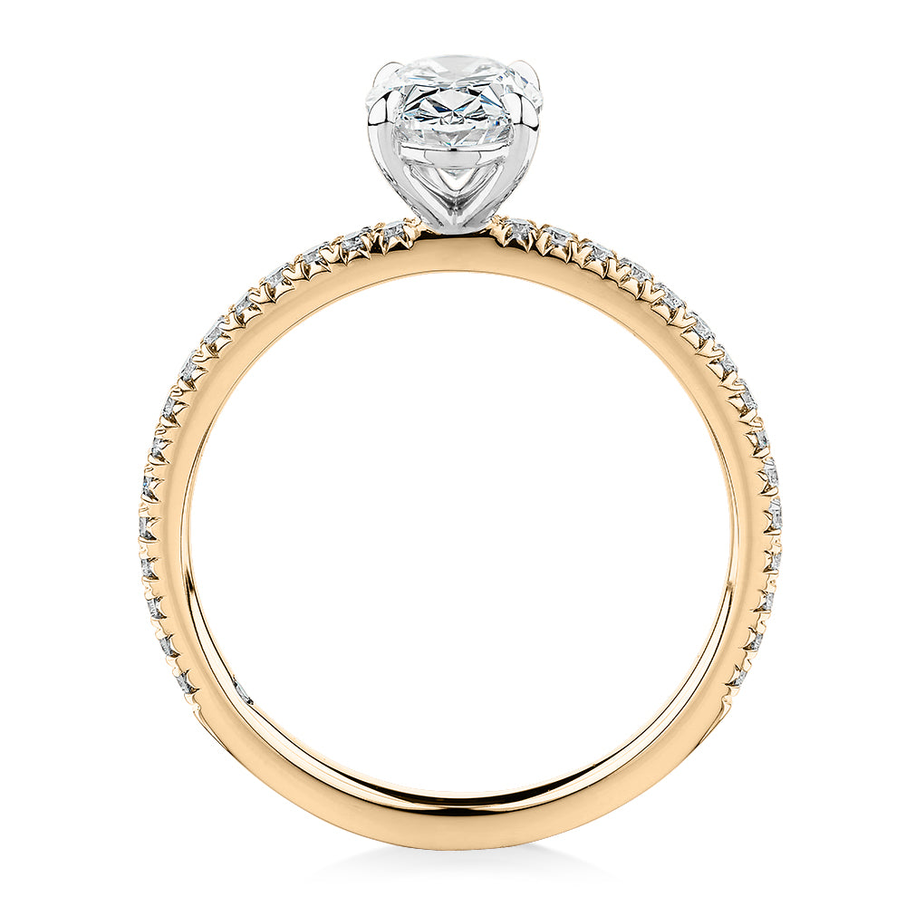 Signature Simulant Diamond 1.24 carat* TW oval and round brilliant shouldered engagement ring in 14 carat yellow and white gold